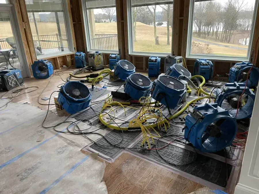 Air movers and drying mats set across a water-damaged Everett room