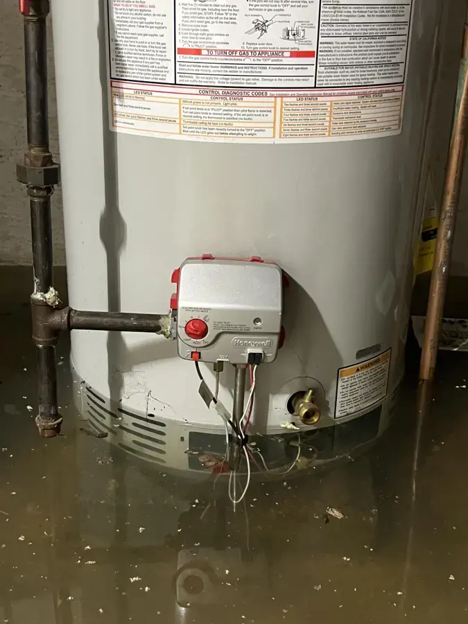 Failed water heater standing in water in an Everett utility space